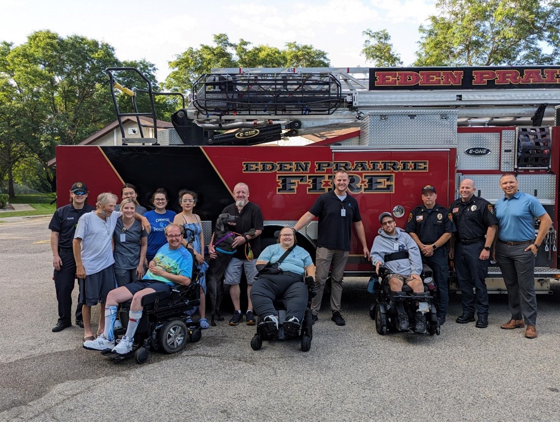 The Lodges Management Team, residents, EP firefighters and Fire Relief Association president pose in front of a fire truck